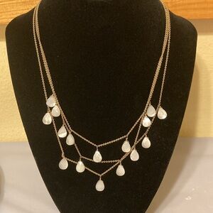 Layered gold tone necklace with faux MOP faceted drop beads